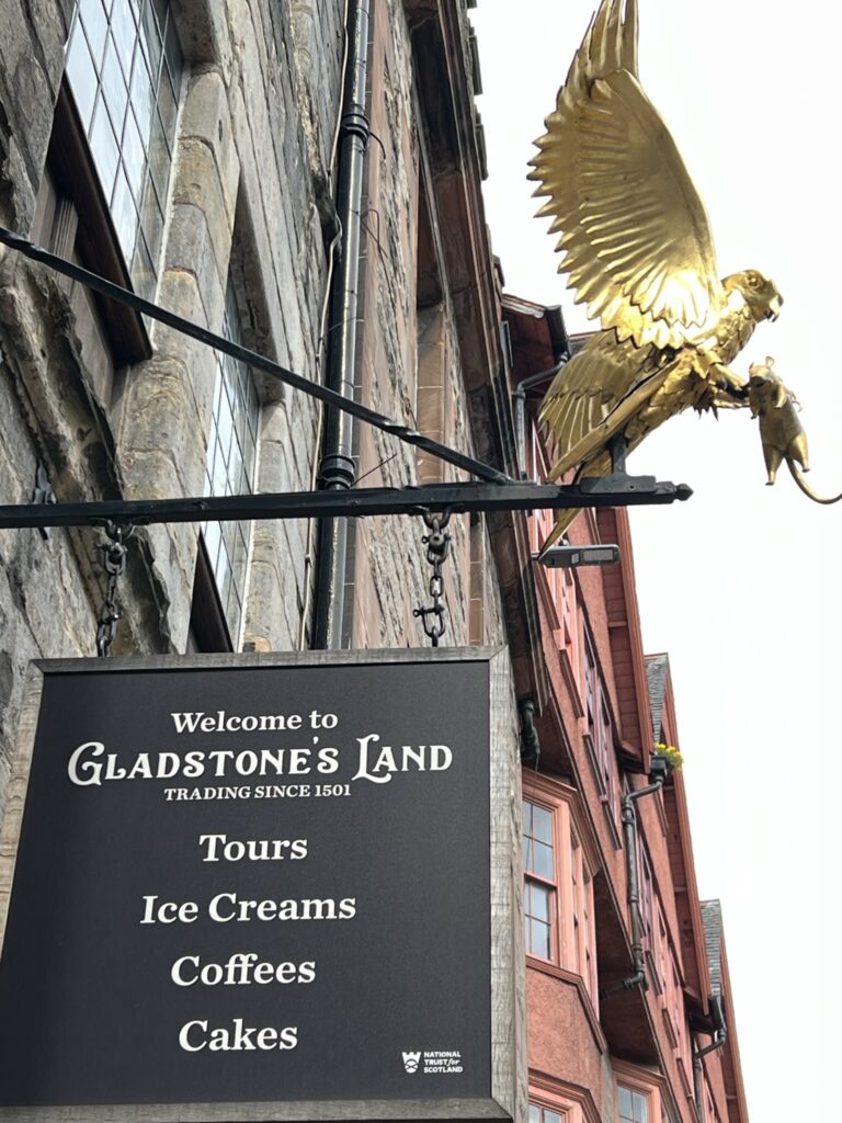 Golden Eagle Sculpture above swinging sign