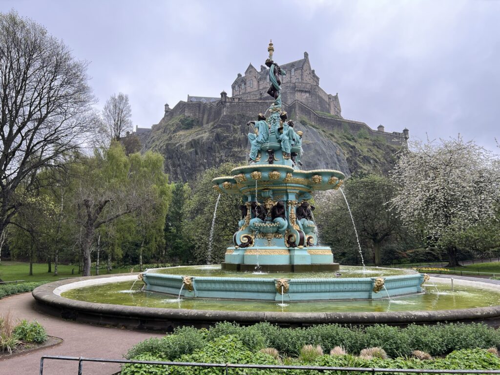 Blue and gold fountain with castle in the background