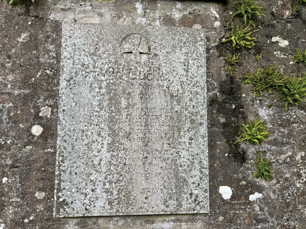 A worn graveslab of the Highland bard